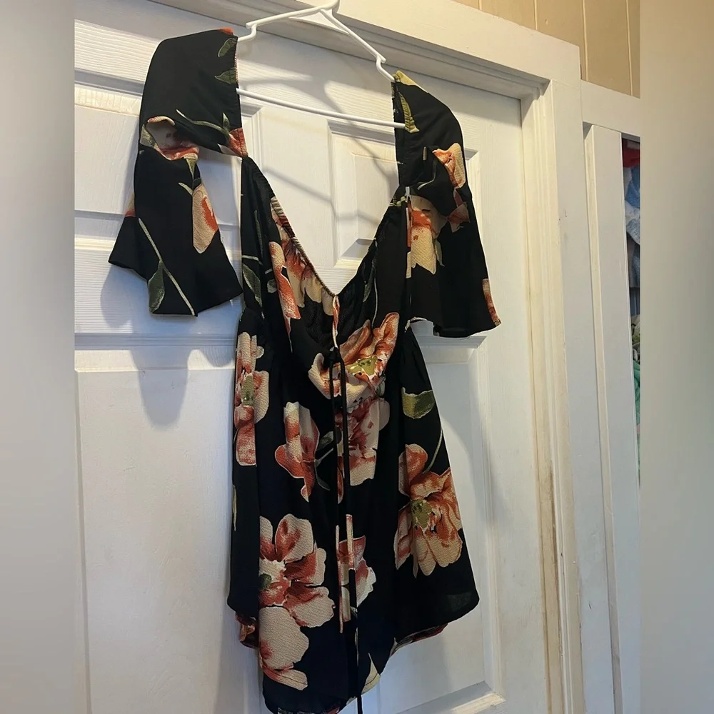NWOT. Black flowy floral off the shoulder 3/4 sleeve romper. - Picture 9 of 11